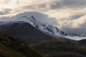 Clouds-engulfing-snow-capped-peaks-Jotunheimen-Norway