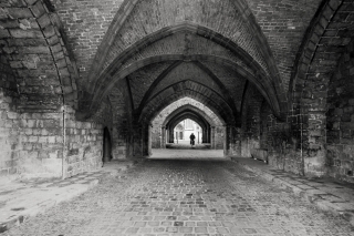 Cyclist-under-brick-archways-Ypres-Belgium