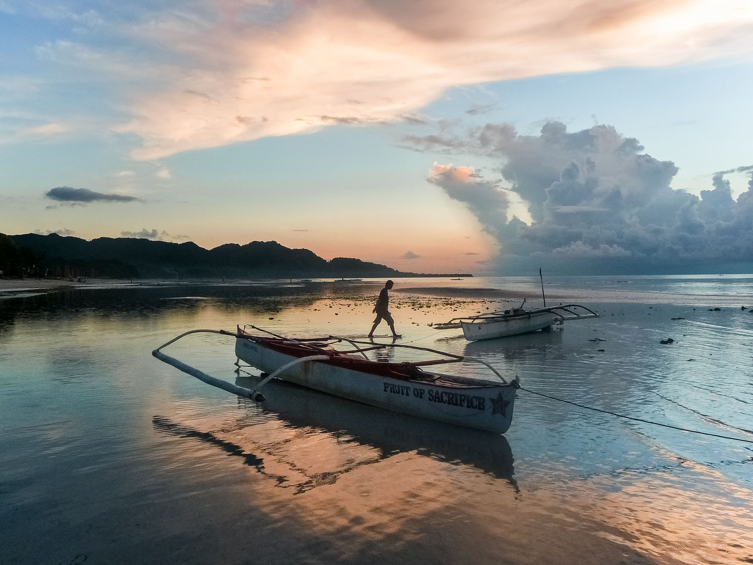 Fisherman-and-bankas-at-sunrise-Anda-beach-Bohol-Philippines