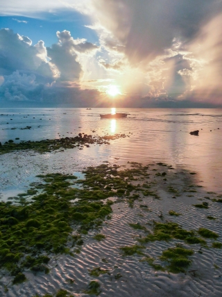 Light-beaming-onto-banka-at-sunrise-Anda-beach-Bohol-Philippines