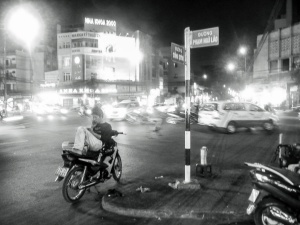 Man-sat-on-motorbike-talking-on-phone-Ho-Chi-Mnih-City-Vietnam
