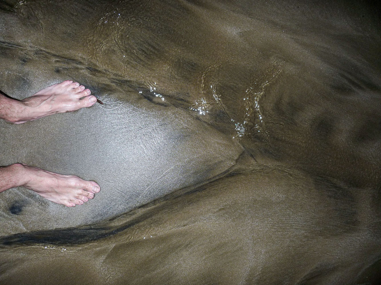 Pair-of-feet-on-sand-left-Kalianda-Sumatra-Indonesia-Wemooch