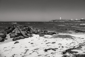 Rocks-on-beach-lighthouse-in-the-distance-South-Western-Australia