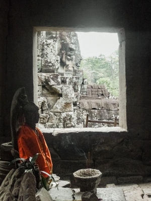 Seated-Budha-with-burning-incense-Angkor-Wat-Cambodia