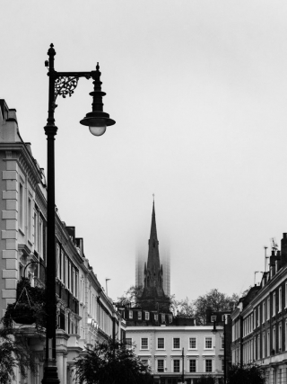 St.Saviours-church-spire-in-front-of-fog-obscured-high-rise-Pimlico-London-England