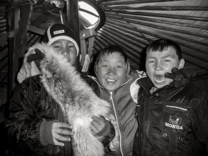 Three-boys-with-fur-inside-ger-obi-Desert-Mongolia.