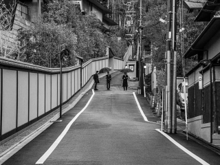 Three-figures-standing-in-the-road-Kyoto-Japan