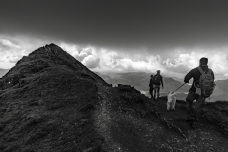 Three-hikers-and-dog-on-summit-of-Mount-Snowdon