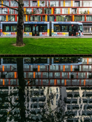Tram-and-building-reflecting-in-canal-Rotterdam-Netherlands.
