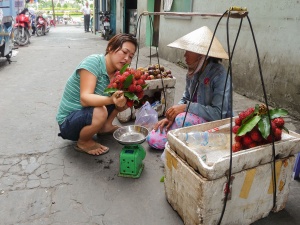 Woman-selling-lychees-to-customer-Ho-Chi-Minh-City-Vietnam