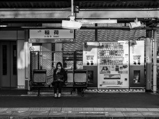 Woman-staring-at-phone-Inari-Station-Kyoto-Japan