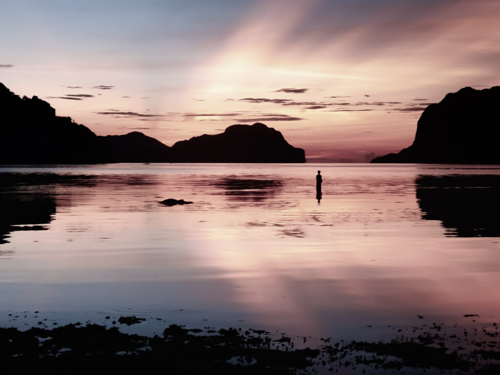 Boy wading at sunset El Nido Palawan Philippines