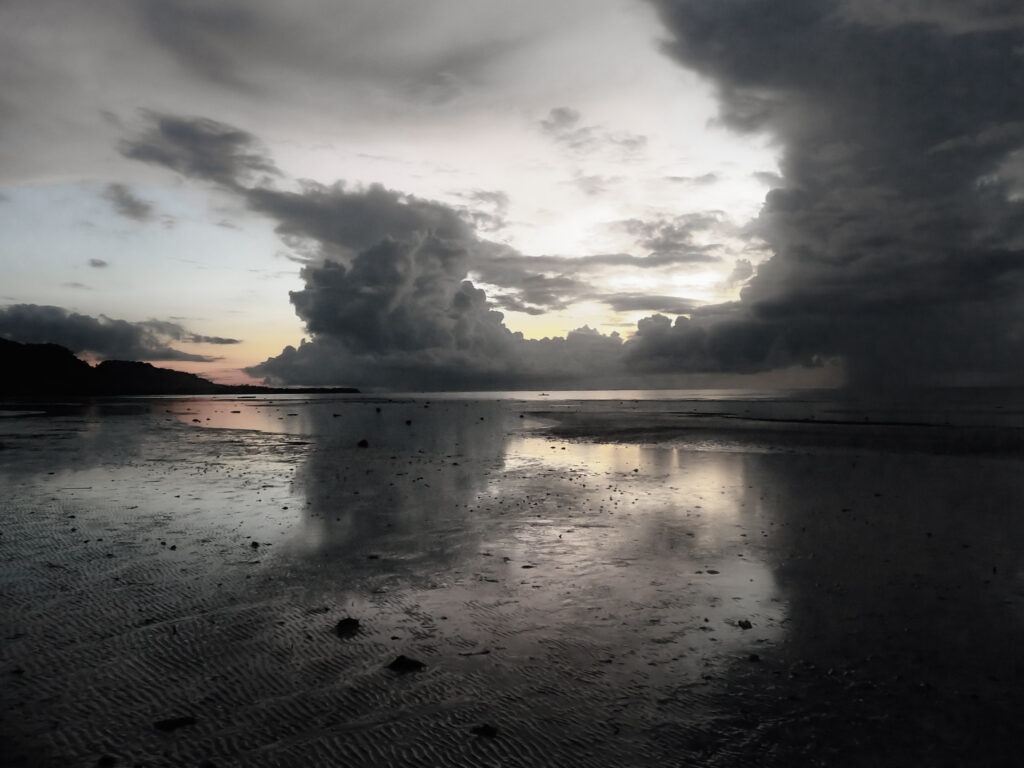 Cloud reflections at sunrise Anda beach Bohol Philippines