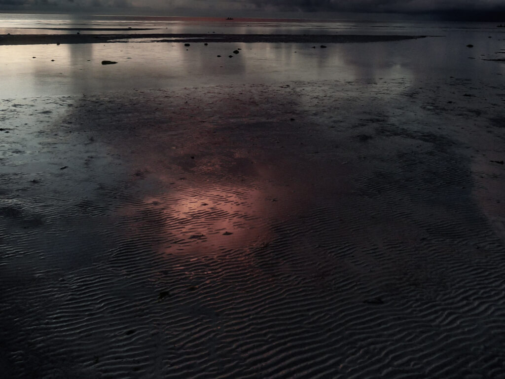 Cloud reflections at sunrise Anda Beach Bohol Philippines